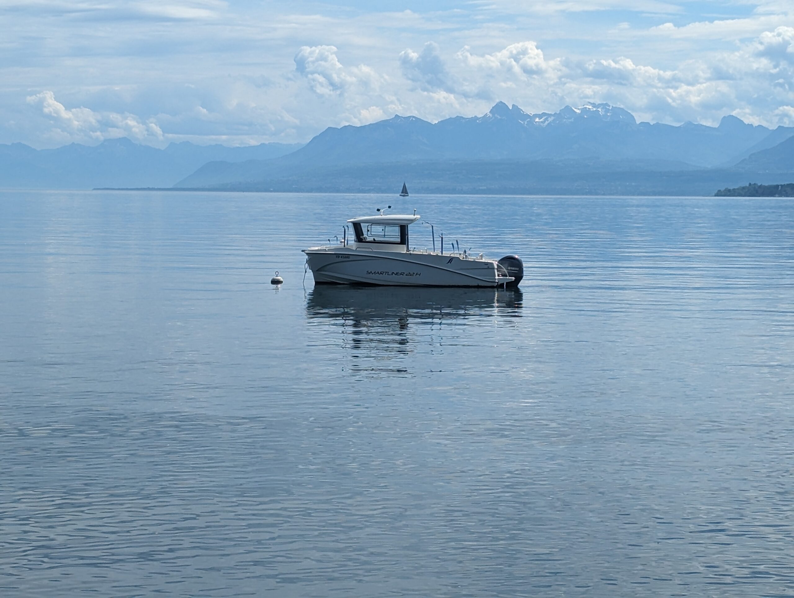 A small, solitary fishing boat on Lake Geneva, Switzerland.